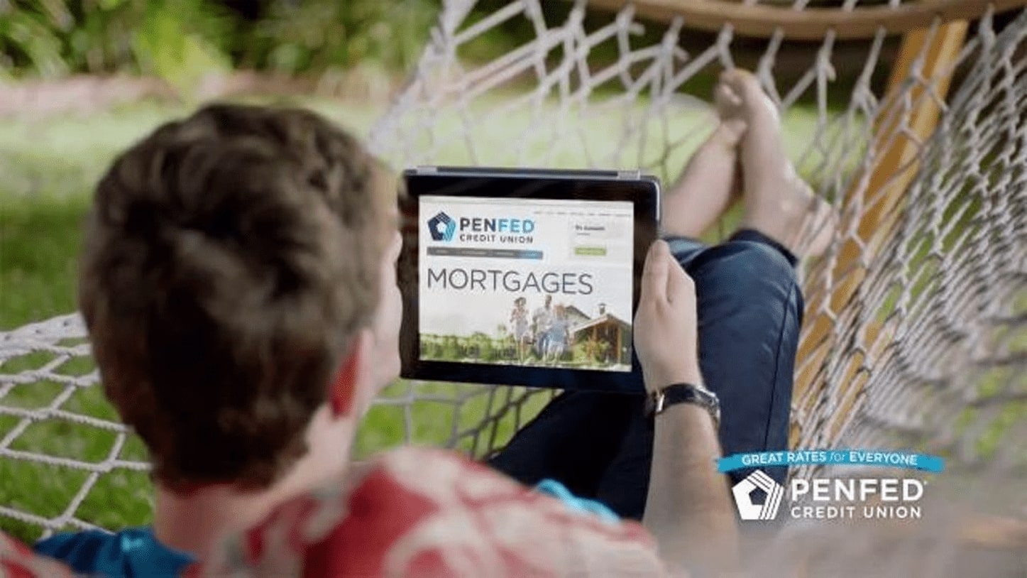 Person looking at ipad with PenFed Credit Union website